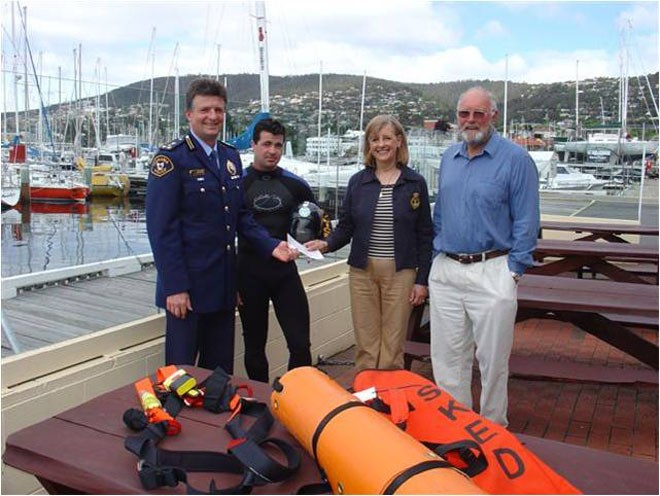 Commander Tom Tully (let) from Tasmanian Air Rescue accepts a donation from RYCT Past Commodore Marion Cooper who presented the cheque on behalf of the SOLAS Trusts © CYCA . http://www.cyca.com.au
